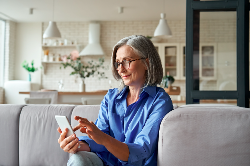 A woman types on her phone