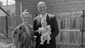 Affirm team member standing with his  wife and holding his their baby