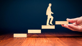 a wooden figure walking up steps