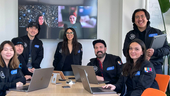 The Philo design team clusters in a conference room with Sandy Micone at the center