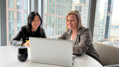 Yang Lu and Annette Hater work on a laptop together.