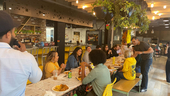 Employees gather for lunch at Sisense’s NYC office kitchen and dining area.