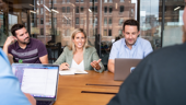 Team members meet to discuss a project.