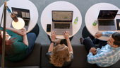 AlertMedia team members working together on laptops
