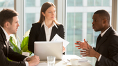 business team sitting at a table discussing a project