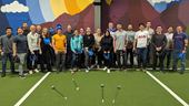 team at an indoor golf space