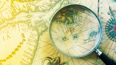 Antique map and magnifying glass