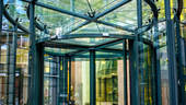 A revolving door in a glass building.
