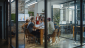 A manager presenting to employees in a conference room.