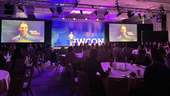 Robin's CEO speaking on stage at a conference.