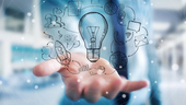 A hand holding a hand drawn lightbulb surrounded by multimedia icons. A hand holding a hand drawn lightbulb surrounded by multimedia icons.