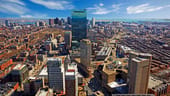 The Boston skyline with Faneuil Hall and Quincy Market in the foreground.