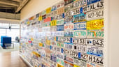 A wall of license plates in CarGurus' Boston office