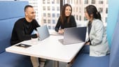coworkers talking at a table