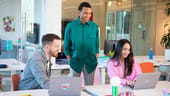 Wix coworkers having a team huddle
