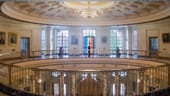 The rotunda at the office with a pride flag hanging in the window