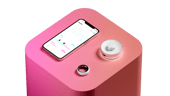 The Happy Ring, pictured with its charger and smartphone app.