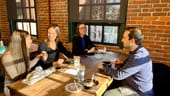 Photo of SmarterTravel coworkers eating a meal at the office.