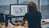 A person faces a computer while designing bicycle parts
