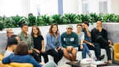 Photo of Foursquare employees gathered on a couch.