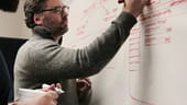 Photo of Charles Plath at a whiteboard.