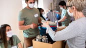 Group of people handing doing volunteer work.
