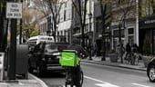A Relay Delivery courier bikes through the city.