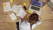 woman at laptop with papers