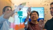 Orchard team members doing an illustration on a board
