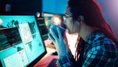 Computer screen, coffee or cyber security woman hacker in dark room for coding.