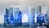 Skyline of modern skyscrapers with a digital overlay.