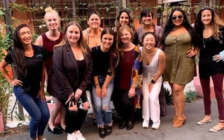 Team members smile at the camera.