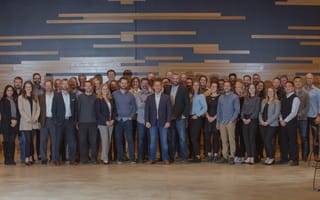 CirrusMD team posing in front of blue and tan wall
