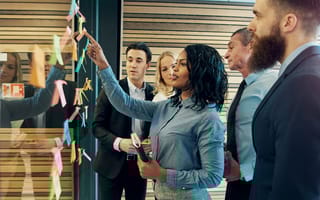 A group of employees work on company goals together.