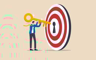 Image of illustrated man inserting golden key into a target