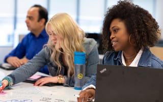 Three TransUnion employees working at a table