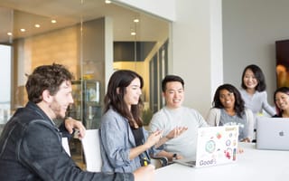 GoodRx employees consult a laptop presentation.