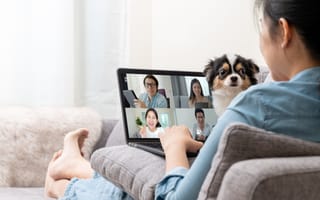 Female employee works from home, with coworkers on Zoom.