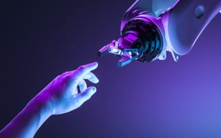 A human hand reaching out to connect with a robot hand.