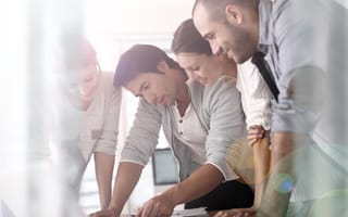 A group of sales reps during a sales meeting.