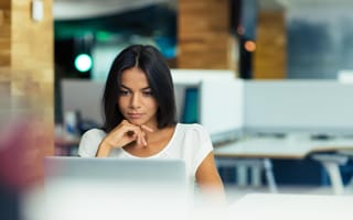 A woman looks confidently on at her work.