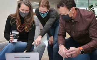 Peakware team huddle meeting
