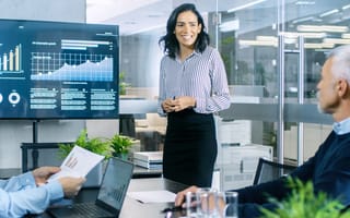 Female sales representative presenting data to clients.