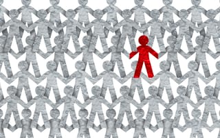 A red figure stands out among a crowd of grey figures.