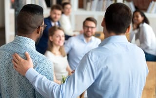New mixed race employee having first working day at company standing in front of colleagues