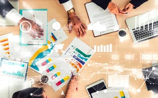 Overhead view of conference table during a marketing and data analysis meeting