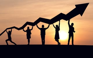 Silhouette of business people and graph at sky and sunset background