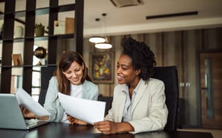 Two women discuss work together.