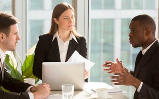 business team sitting at a table discussing a project