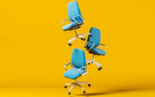 hree blue office chairs float in front of a yellow background.